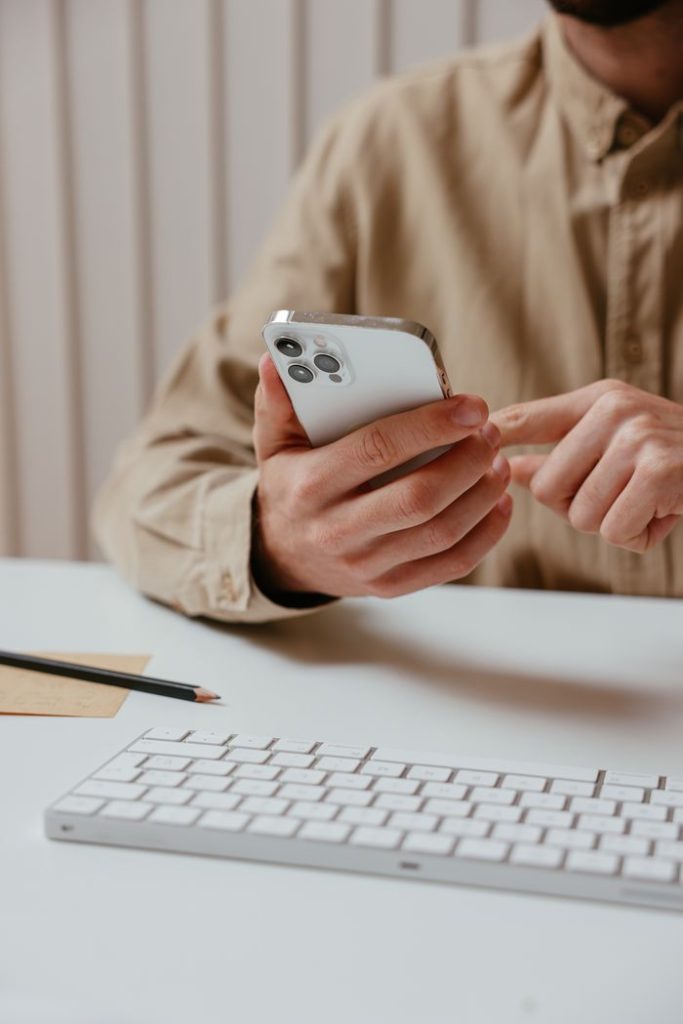 a-person-using-his-smartphone-7657615